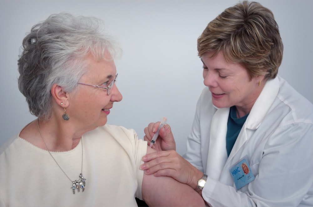 A nurse caring for a smiling older woman